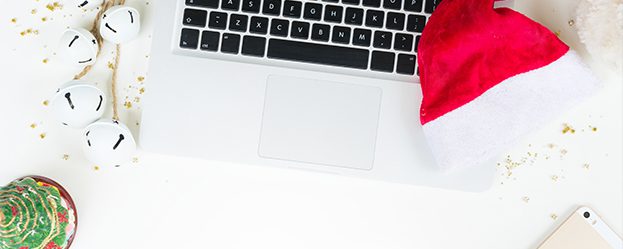 Christmas decorations around a laptop