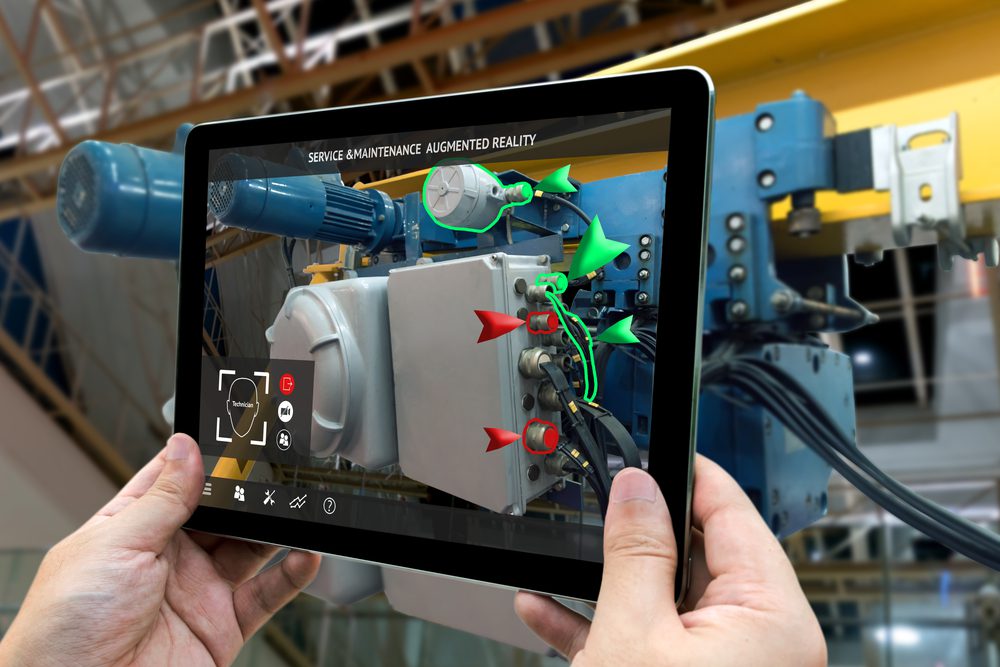 Hand holding tablet with AR service , maintenance application and calling technician for check destroy part of smart machine in smart factory background