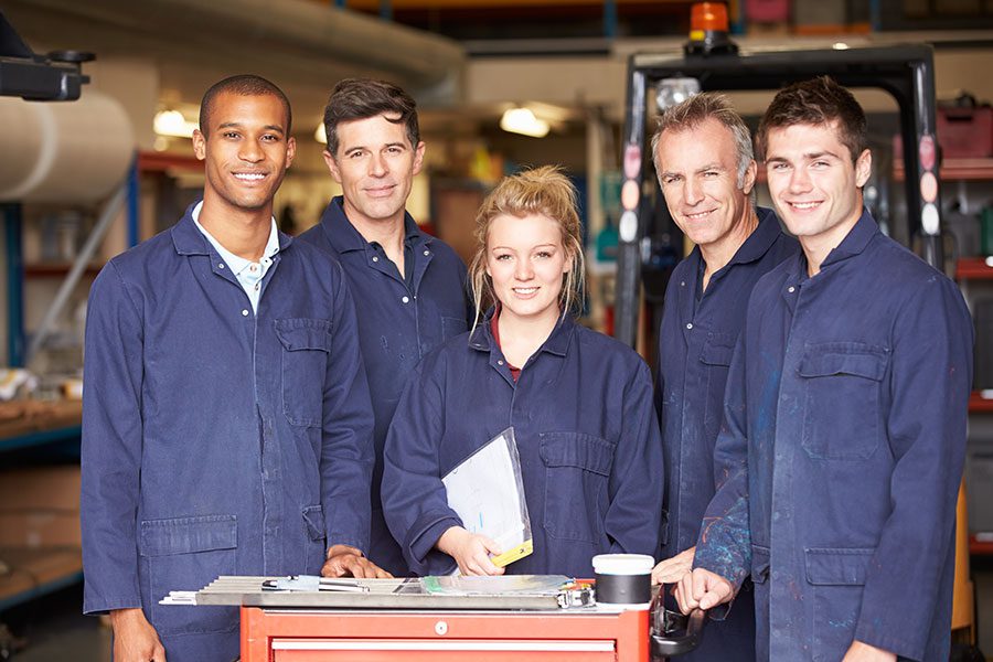 A group of smiling manufacturing employees