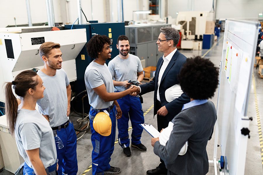 A manager in manufacturing shaking hands with an operative